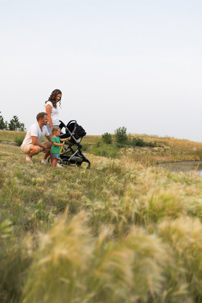 Young family enjoying views of a tranquil pond in Amble, showcasing natural amenities and opportunities to connect with nature.