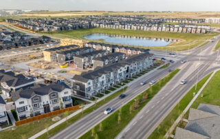 Aerial view of StreetSide townhomes in Redstone showcasing the community, with a scenic pond and naturalized green space located across the street.